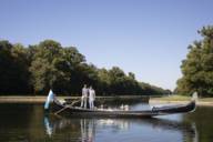 Father and son Koch stand on their gondola on the Nymphenburg Canal.