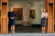 Isabel Grosse and Sabine Renner stand in front of the entrance to the RENNER & GROSSE Collection.